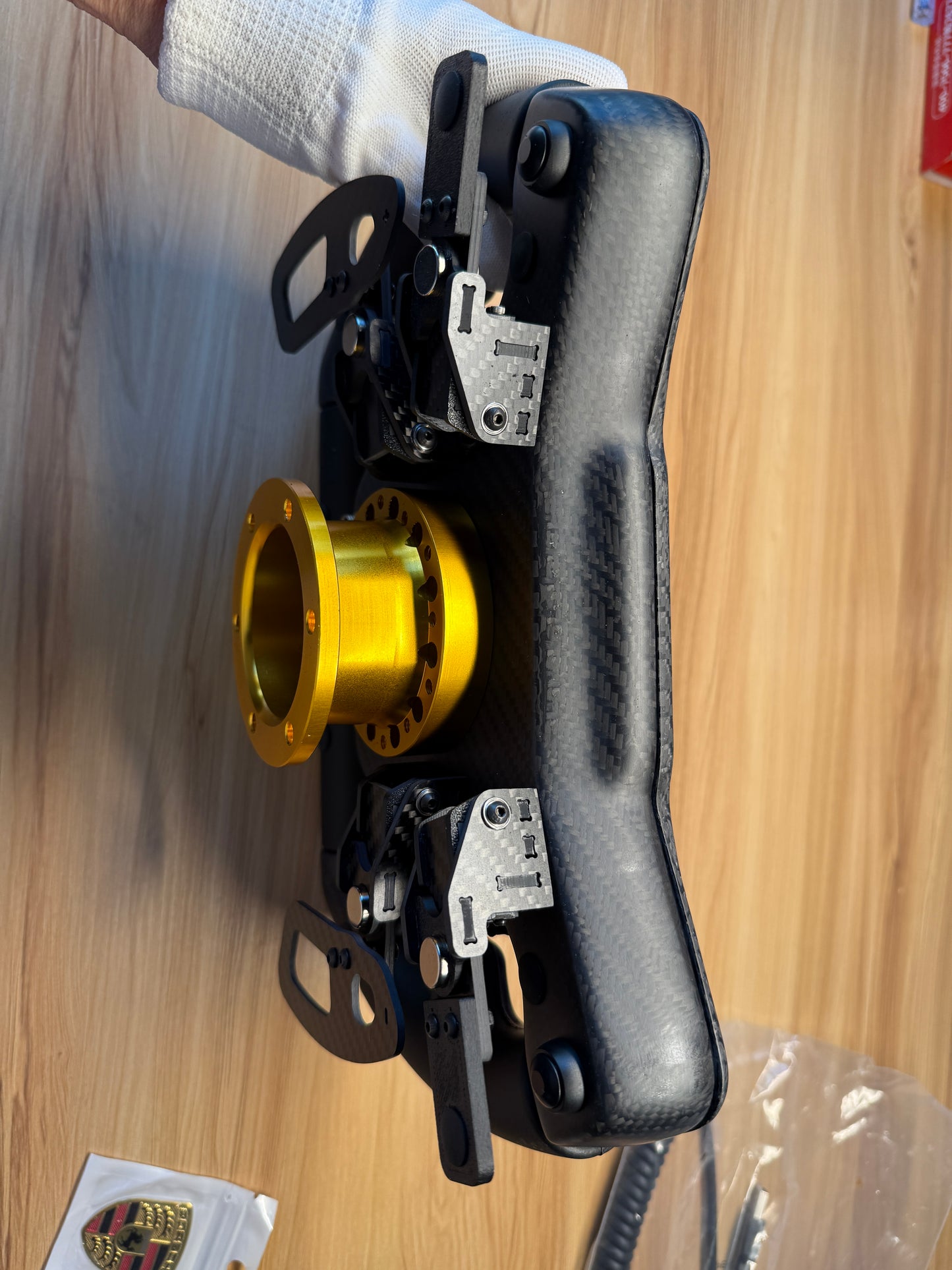 Vertical image of the 992R Sim Racing GT Wheel, featuring a black carbon fiber frame, ergonomic grips, and precision controls, designed for realistic and professional sim racing experiences.