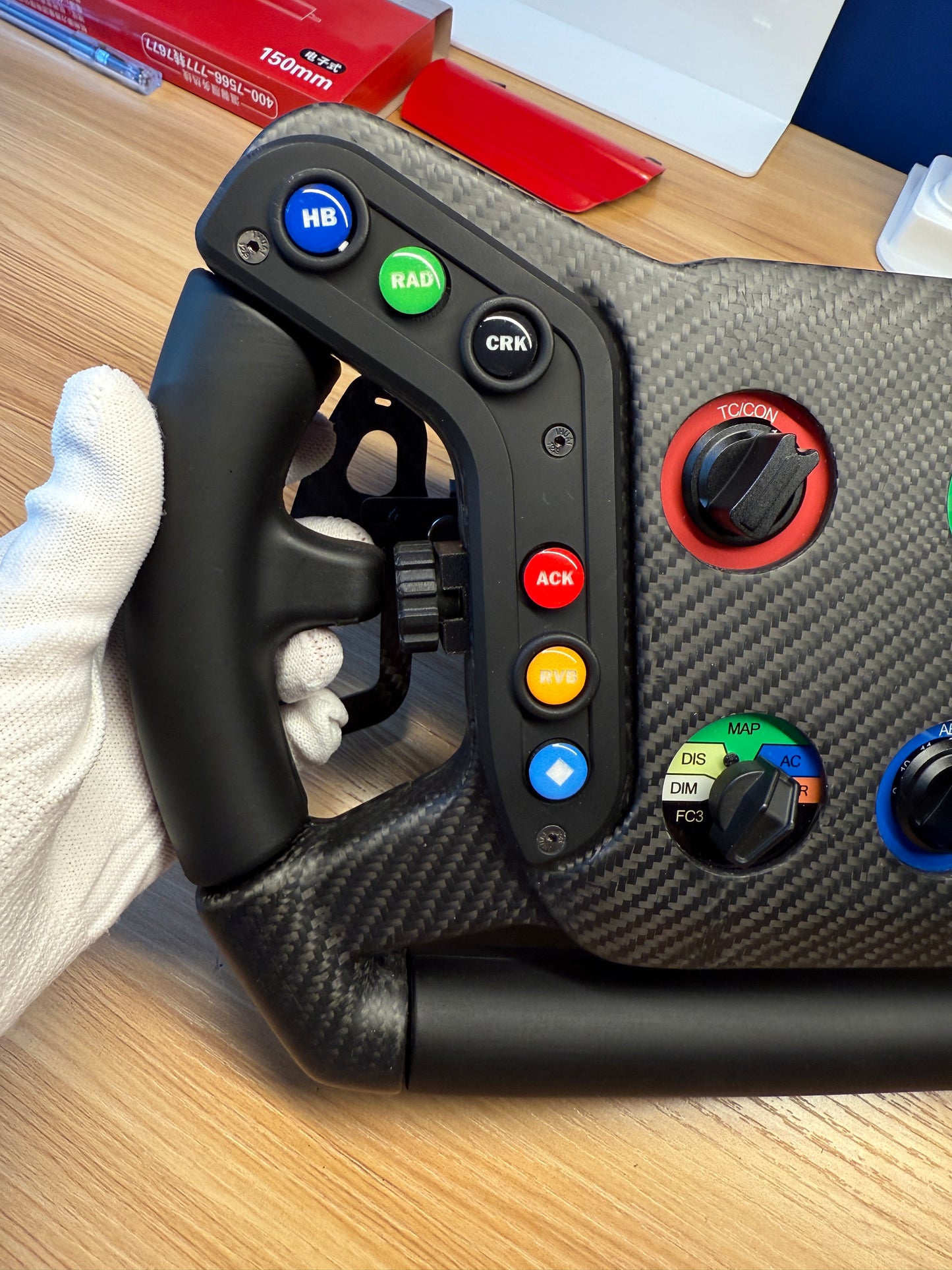 vertical product image of the 992R Sim Racing GT Wheel by Powerful Steering, featuring lightweight black carbon fiber frame, ergonomic hand grips, and precision racing controls. Designed for professional and enthusiast sim racing setups, compatible with Moza and major wheel bases, engineered for maximum durability, high performance, and realistic racing simulation experience.