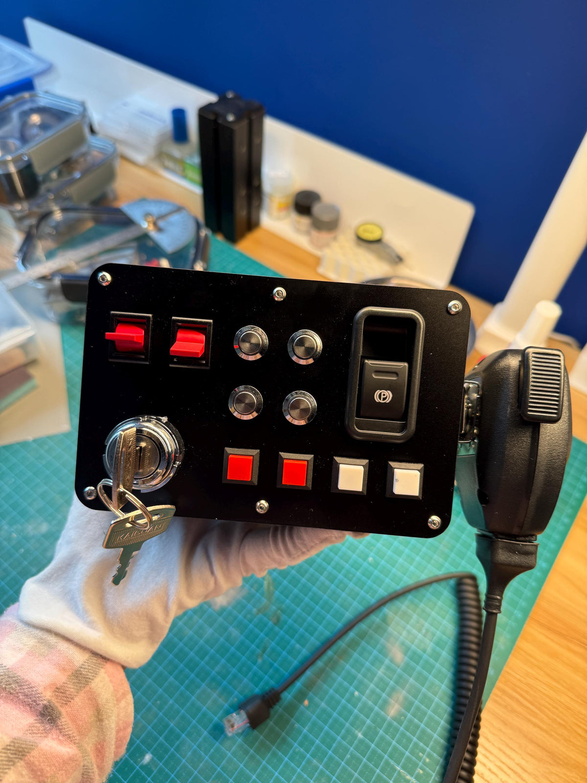 Truck sim button box controller front panel close up — ignition key, parking brake switch, toggle switches and rotary encoders for Euro Truck Simulator 2