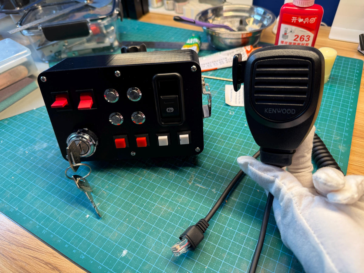 ETS2 truck sim button box controller and handheld mic side by side showing USB connector cable, workshop build shot
